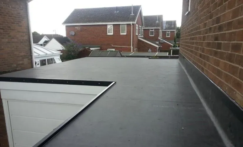 A newly installed flat roof on a residential extension or garage, showcasing modern flat roofing systems